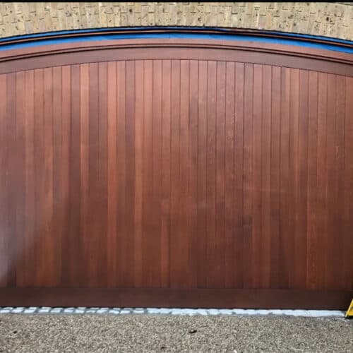 Cedar Door Custom Design Arched Top Timber Up & Over Garage Door in Walnut with Matching Curved Timber Frame