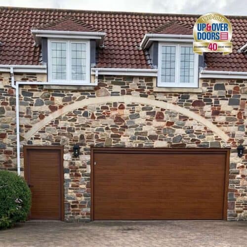 Garador & Hormann Linear Small Insulated Sectional Door in Golden Oak with Matching Pass Door