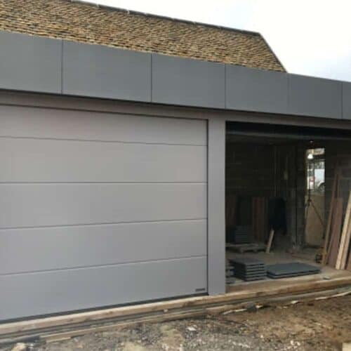 Hormann Linear Large Insulated Sectional Doors in Stone Grey with Custom Aluminium Fascia