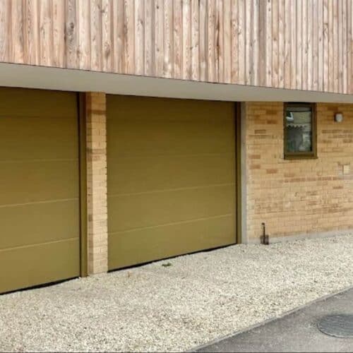 Pair of AluTech L Rib Insulated Sectional Doors in Custom Colour with Matching Front Door